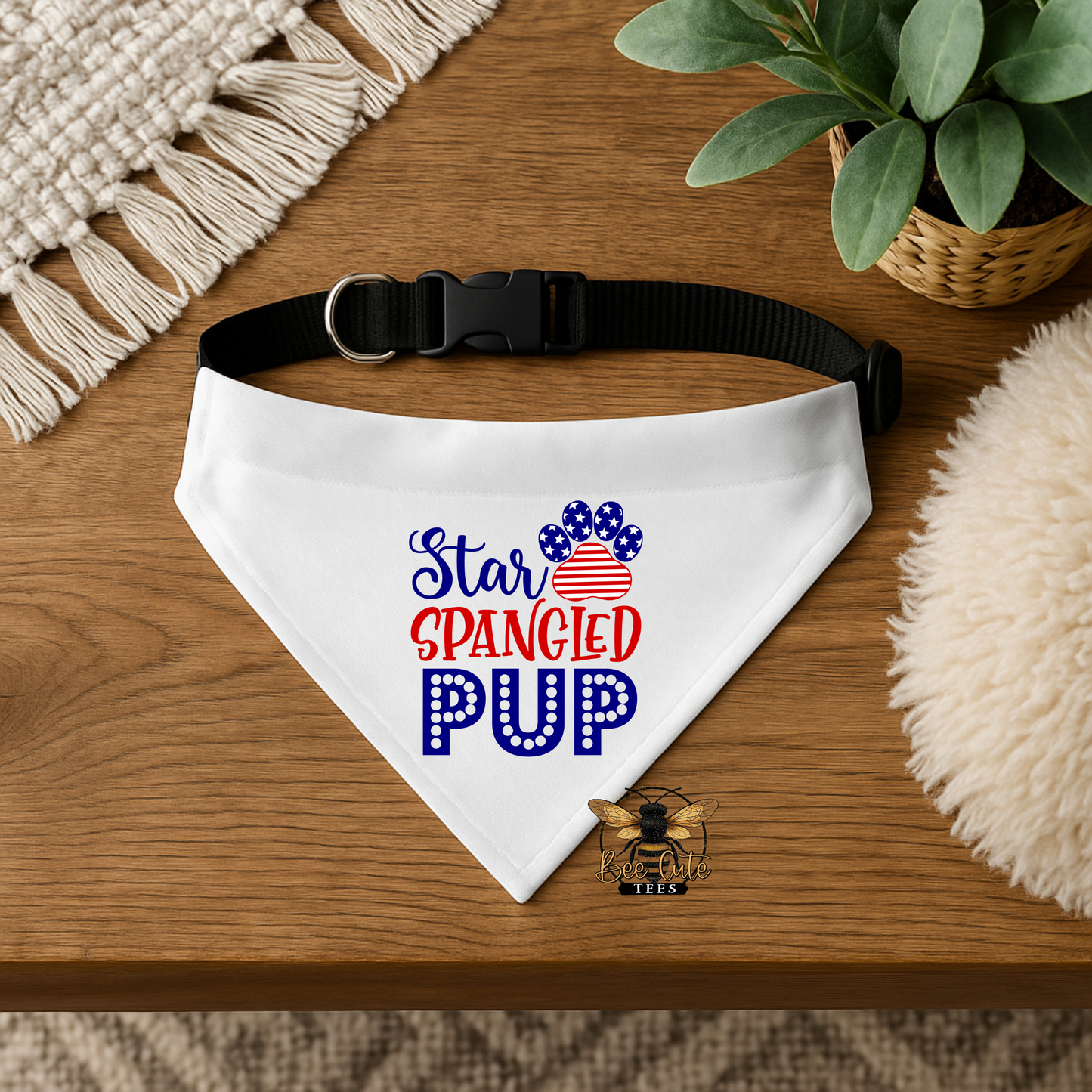 White dog bandana with 'Star Spangled Pup' text on a wooden surface