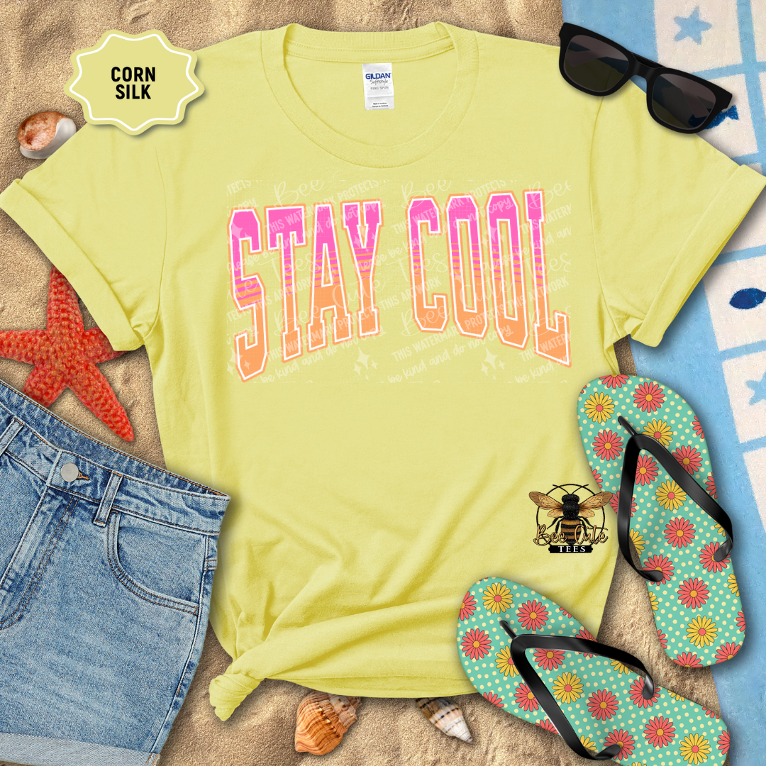 Yellow t-shirt with 'Stay Cool' text, sunglasses, denim shorts, and flip-flops on a beach-themed background.