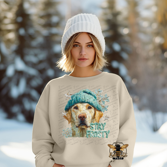 Person wearing a beige sweatshirt with a dog graphic and 'Stay Frosty' text in a snowy landscape.