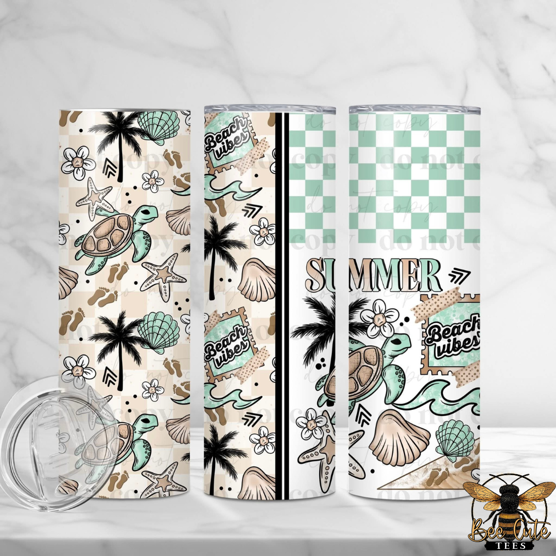 Three tumblers with beach-themed designs on a white background