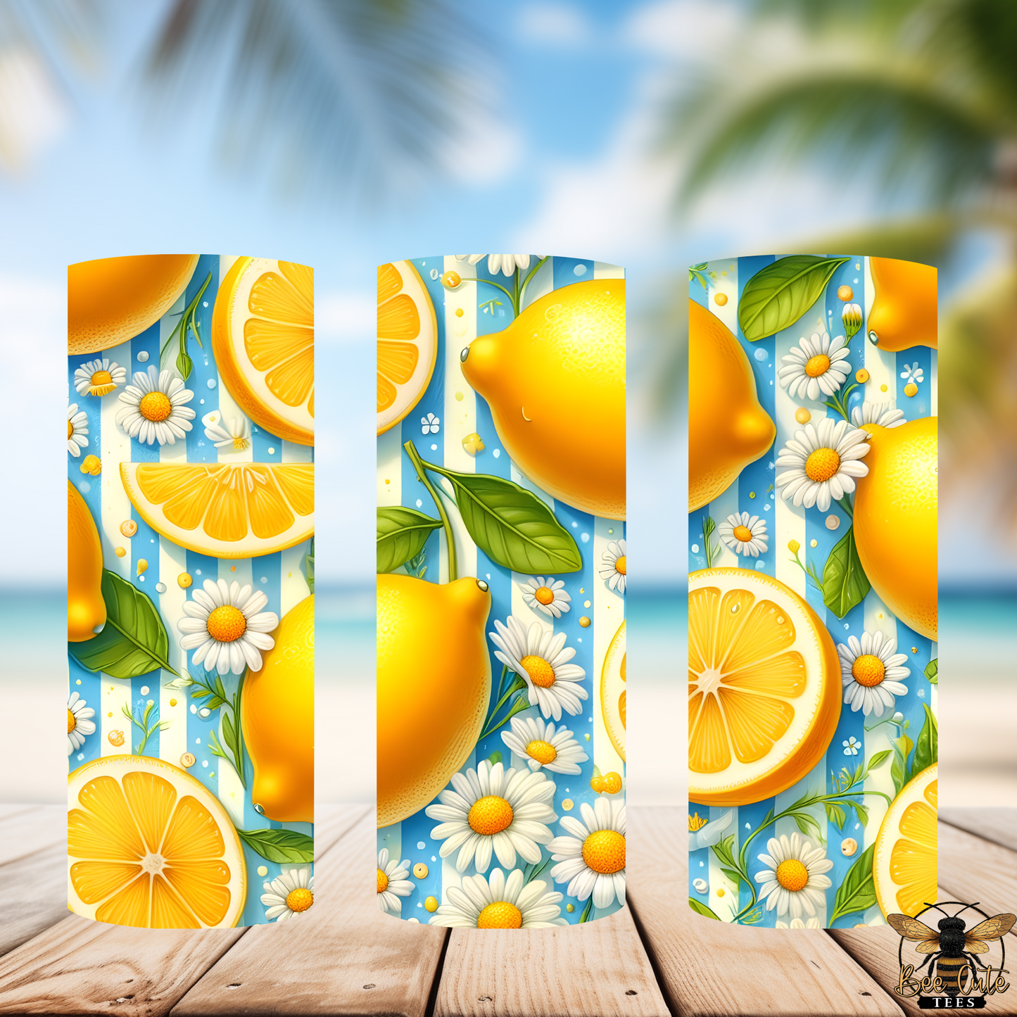 Decorative tumblers with lemons, oranges, and daisies on a blue striped background.