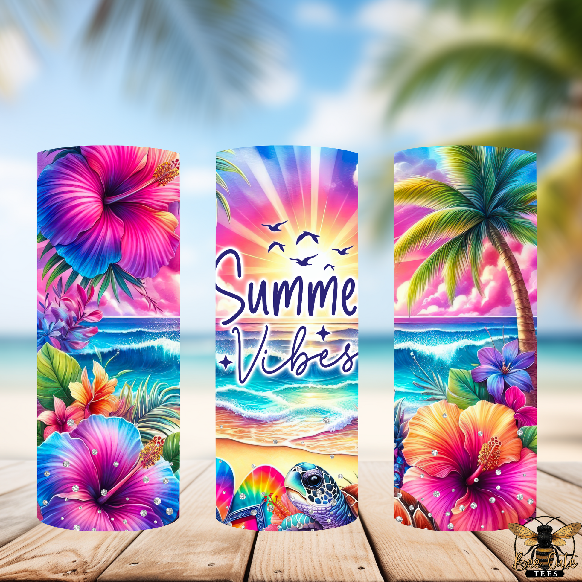 Three colorful beach-themed tumblers with floral and tropical designs on a wooden surface.