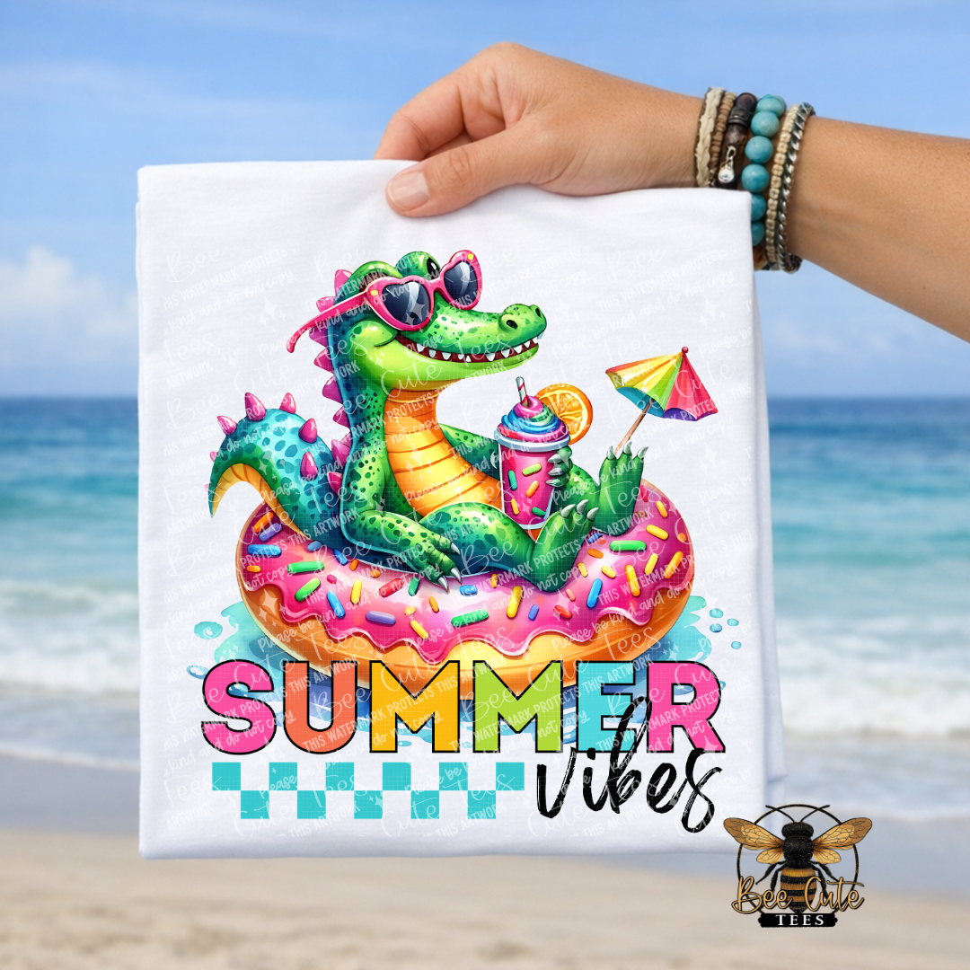Colorful alligator on a donut float with 'Summer Vibes' text, held against a beach background.