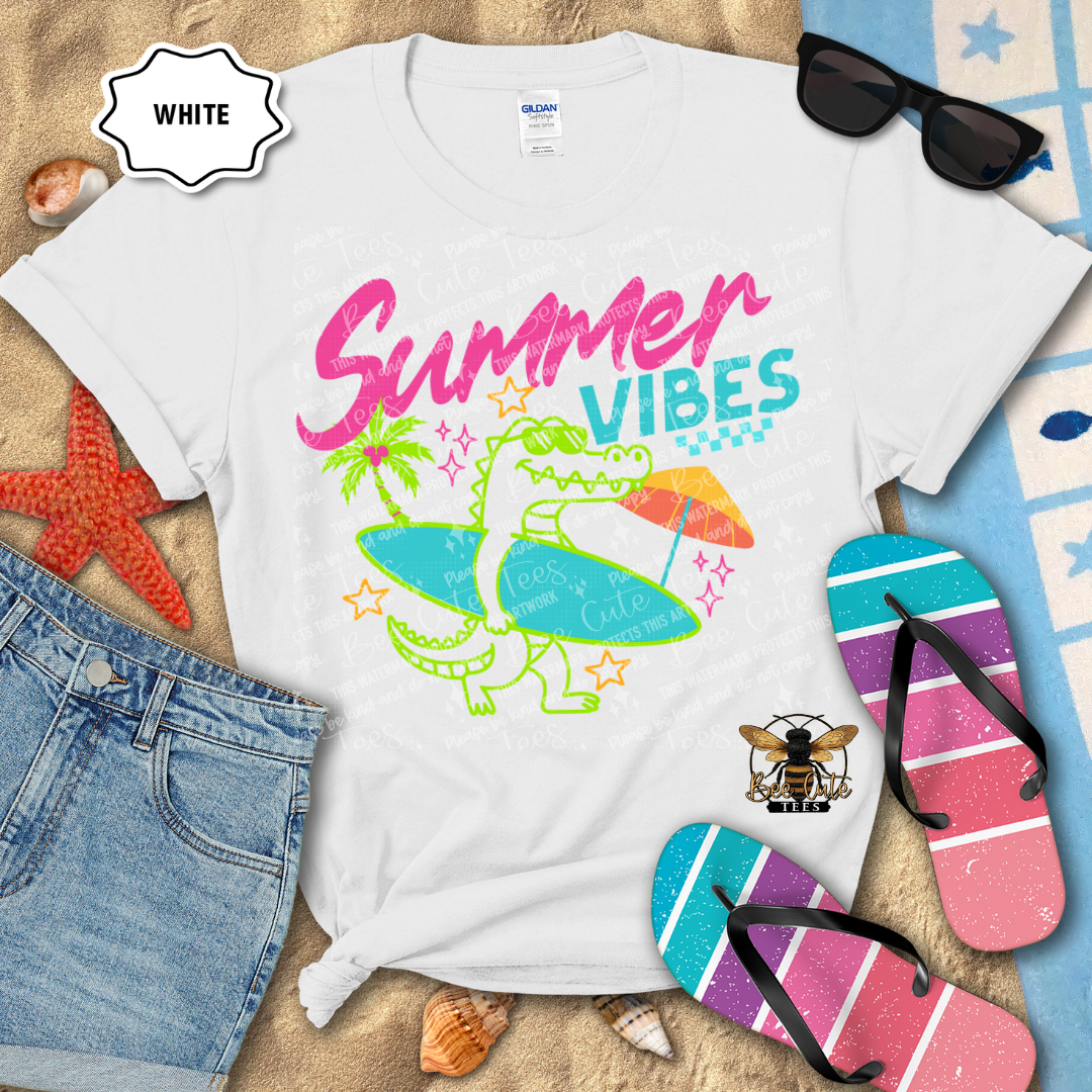 White t-shirt with 'Summer Vibes' design, sunglasses, and flip-flops on a beach-themed background.