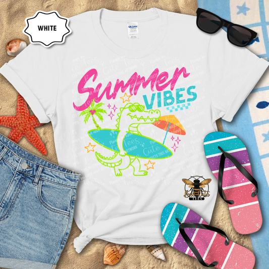 White t-shirt with 'Summer Vibes' design, sunglasses, and flip-flops on a beach-themed background.