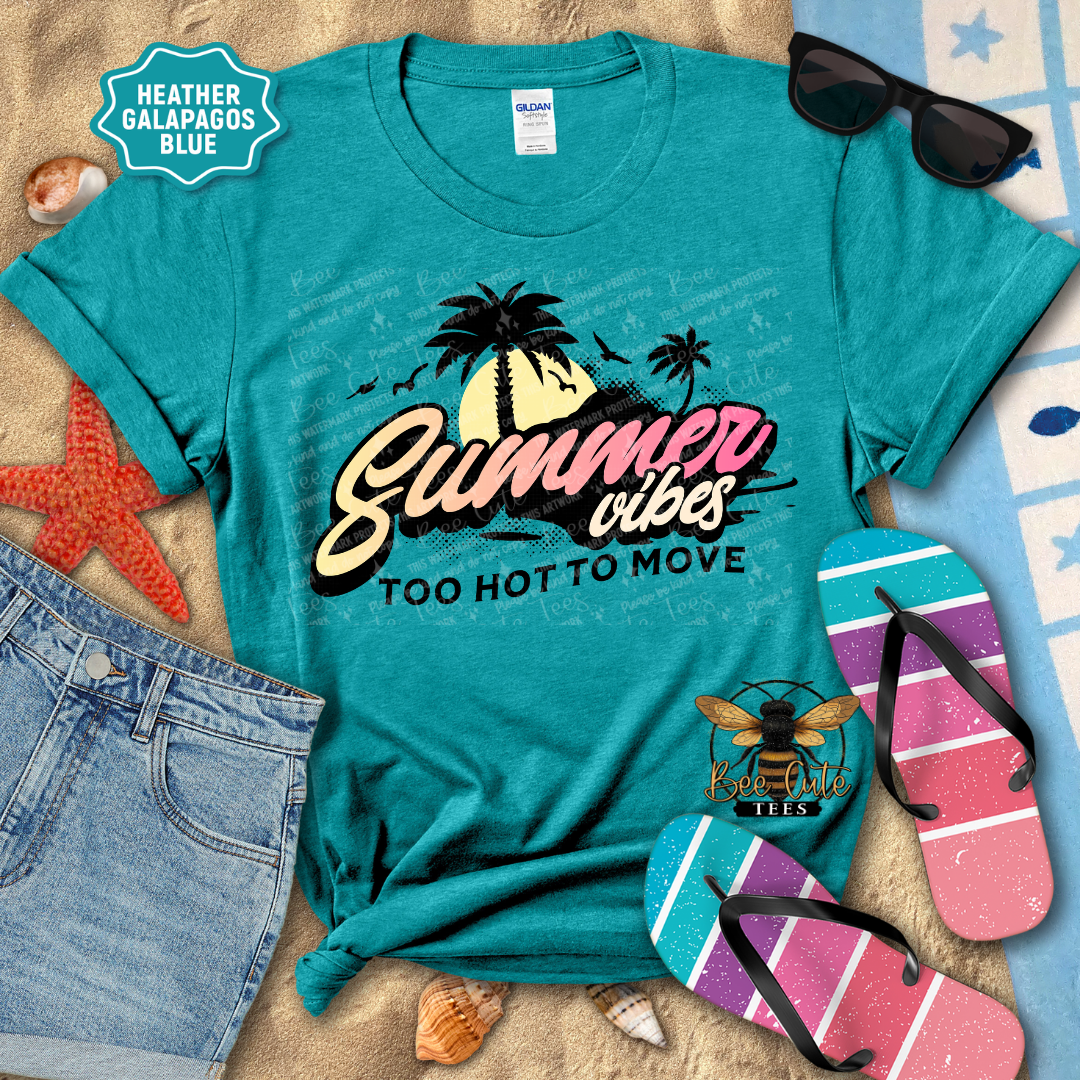 Teal t-shirt with 'Summer vibes too hot to move' design, sunglasses, flip-flops, and beach items on a wooden surface.
