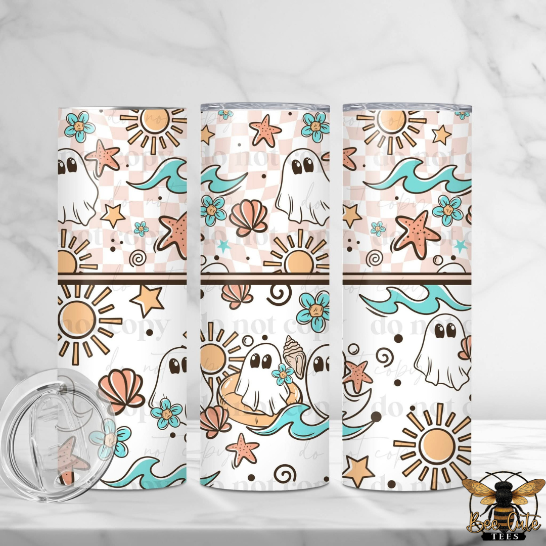 Three tall tumblers with a repeating ocean-themed print featuring ghosts, suns, waves, shells, and starfish on a white background, shown with a clear lid on a light marble surface.