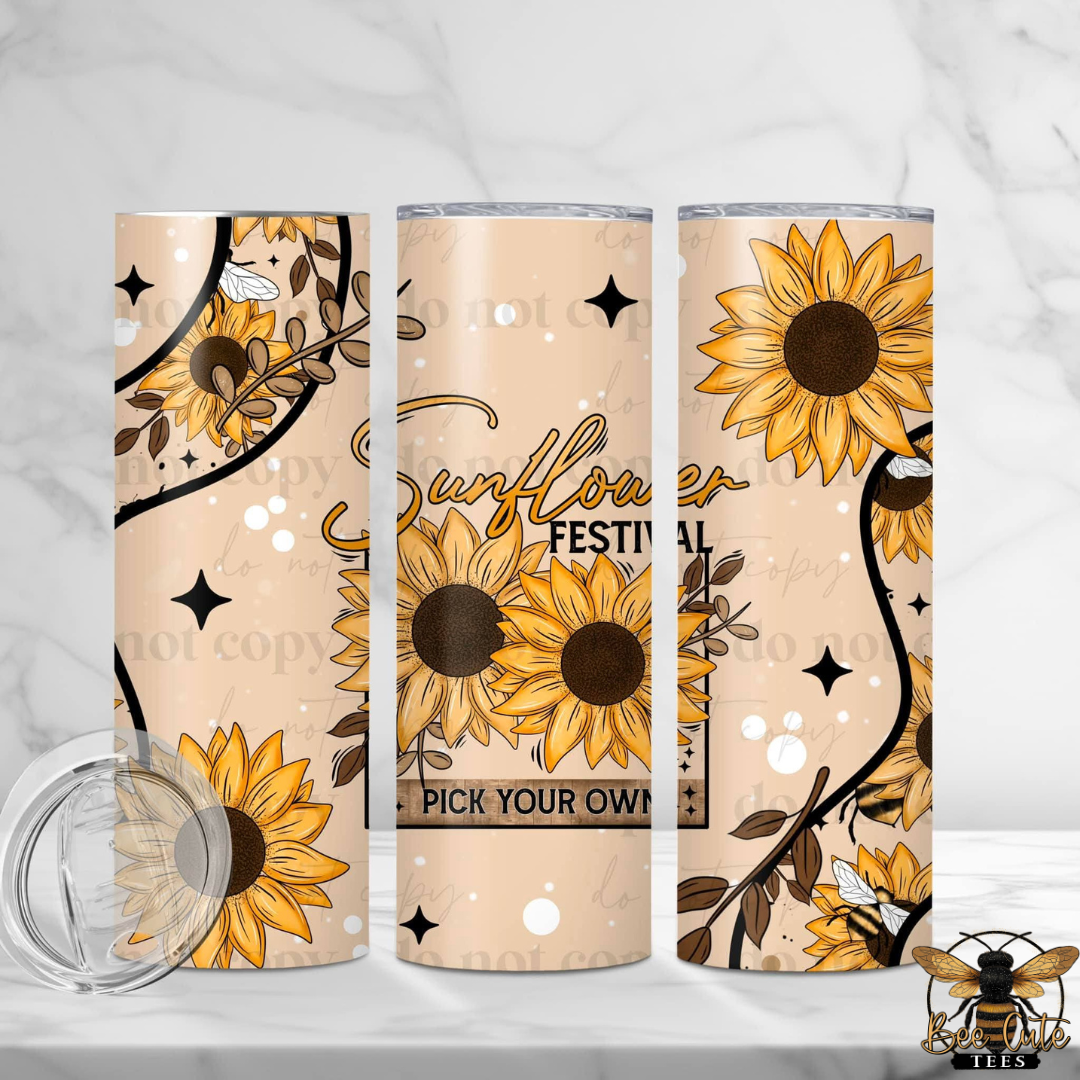 Three views of a tall insulated tumbler with a sunflower and bee design on a beige background, shown on a light marble surface with a clear lid in the foreground.