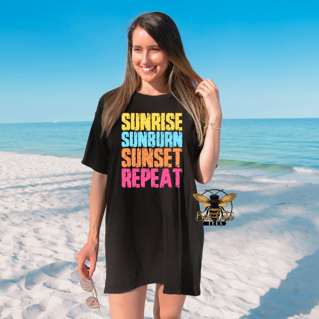 Woman wearing a black t-shirt with colorful text on a beach