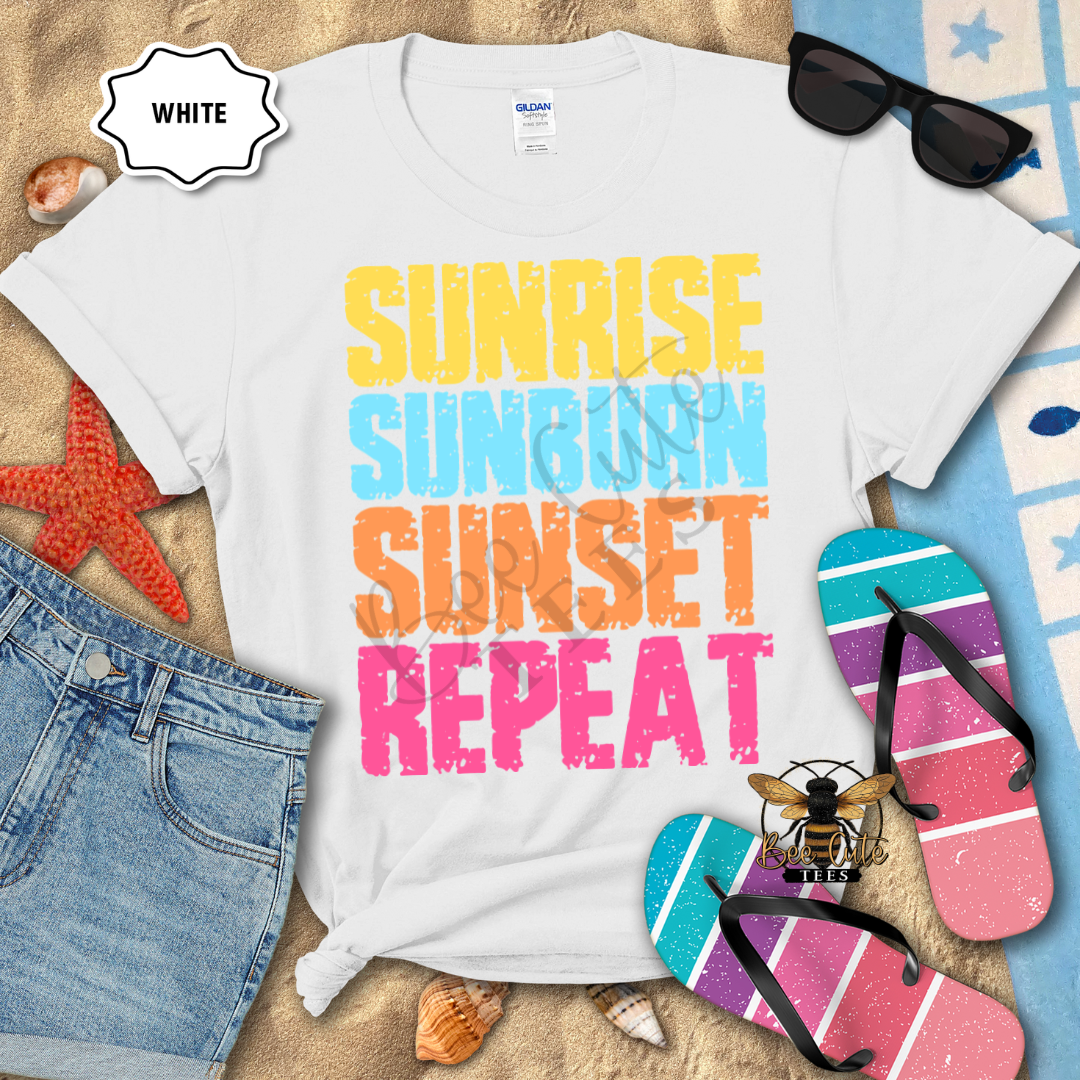 White t-shirt with 'Sunrise Sunburn Sunset Repeat' text on a beach background with accessories.