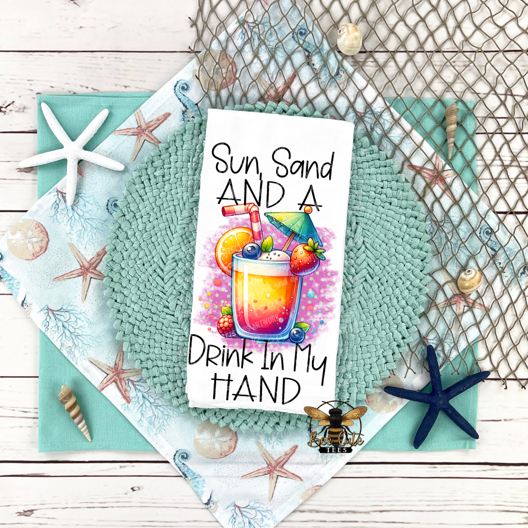 Tea towel with a beach theme featuring a drink illustration and text on a textured surface.
