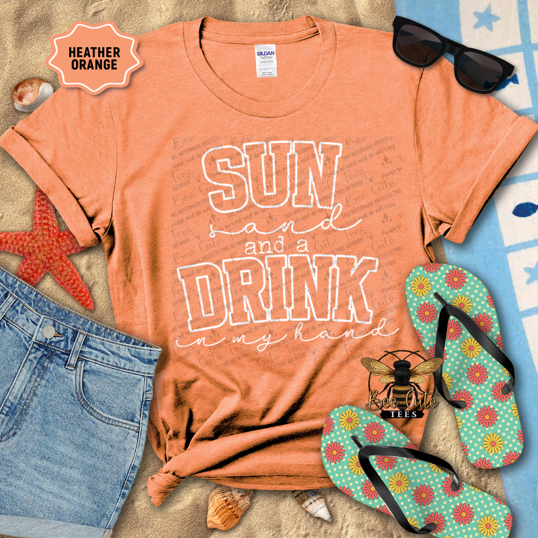Orange t-shirt with 'Sun and a Drink in my hand' text, sunglasses, and flip-flops on a beach-themed background.