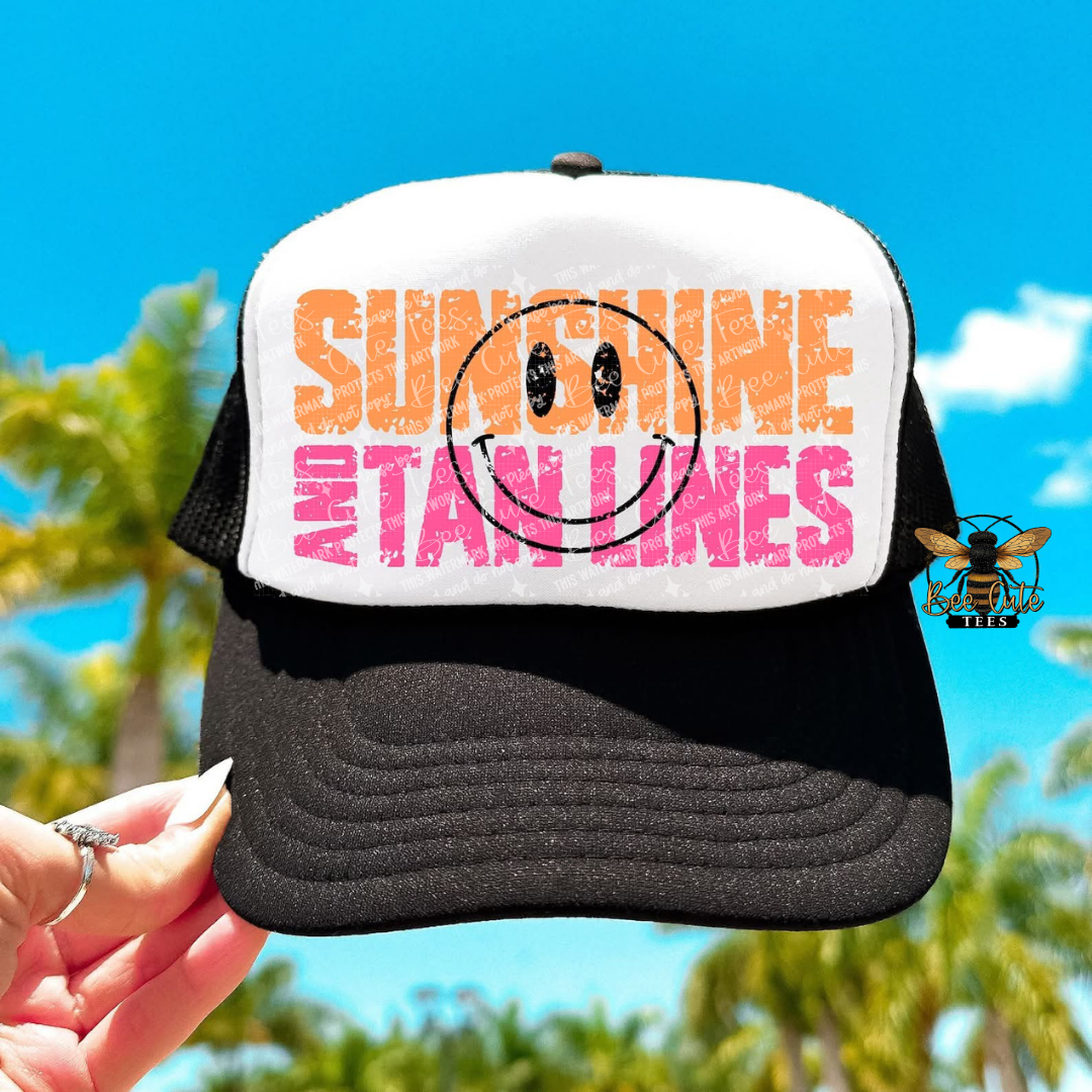 Trucker hat with 'Sunshine and Tan Lines' text against a blue sky background