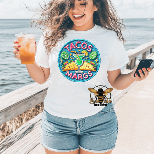 Woman wearing a t-shirt with 'Tacos Margs' design by the ocean