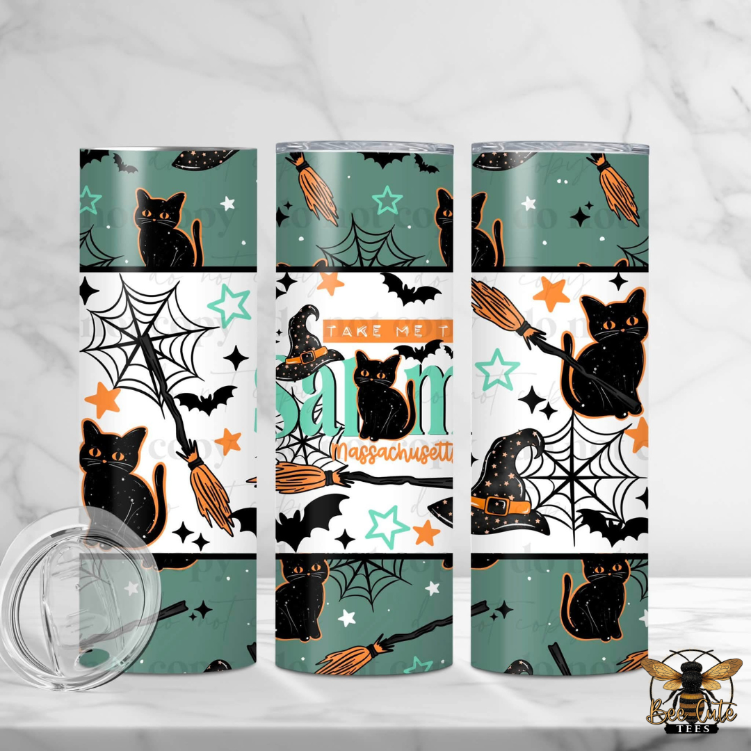 Three insulated tumblers with a Halloween-themed wrap design featuring black cats, bats, broomsticks, spiderwebs, stars, and orange accents on a white and teal background. The center tumbler has the text 'TAKE ME TO MASSACHUSETT' wrapped around the middle.
