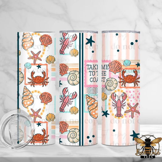 Set of three tumblers with beach-themed designs on a white background