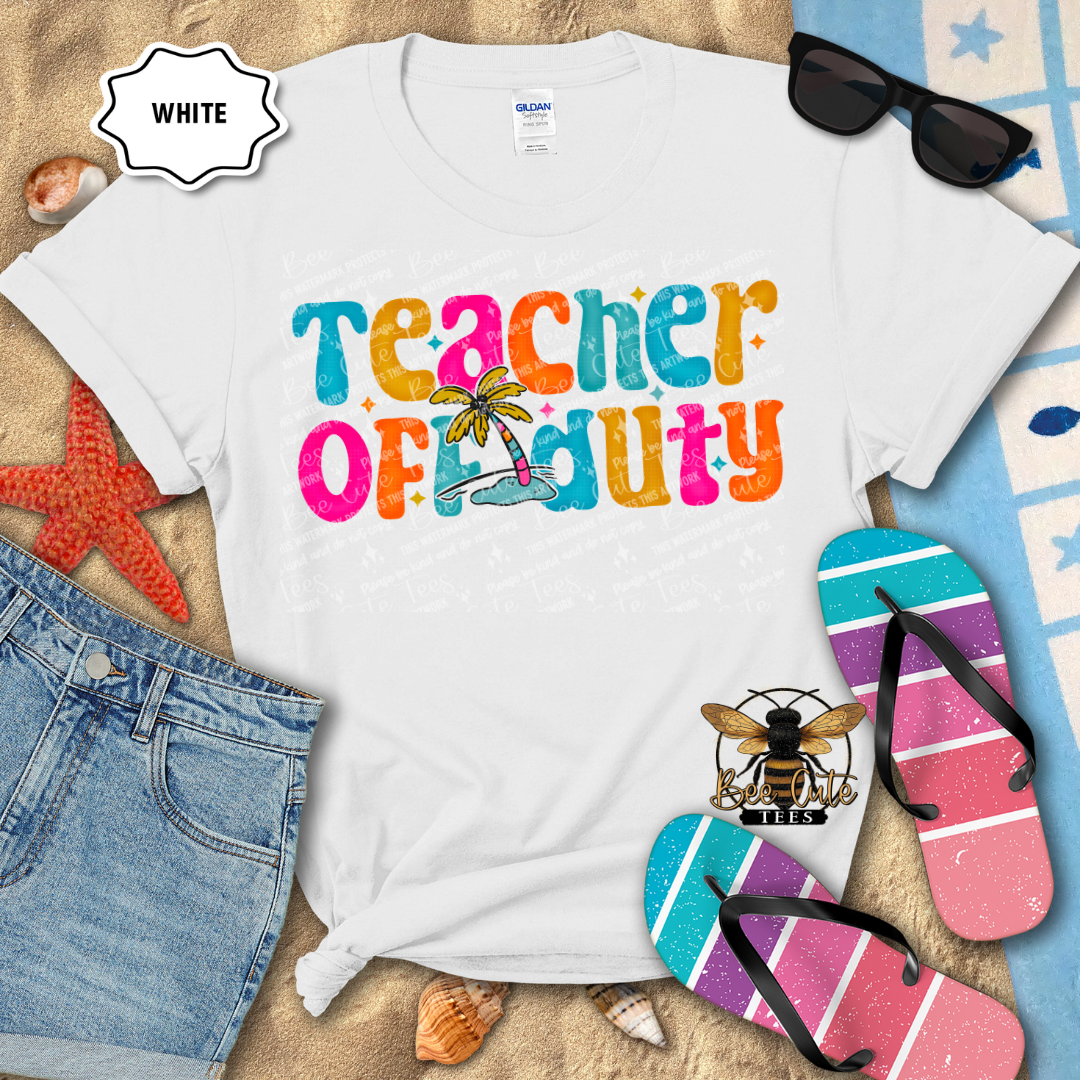 White t-shirt with 'Teacher Off Duty' text, sunglasses, denim shorts, and flip-flops on a sandy background.