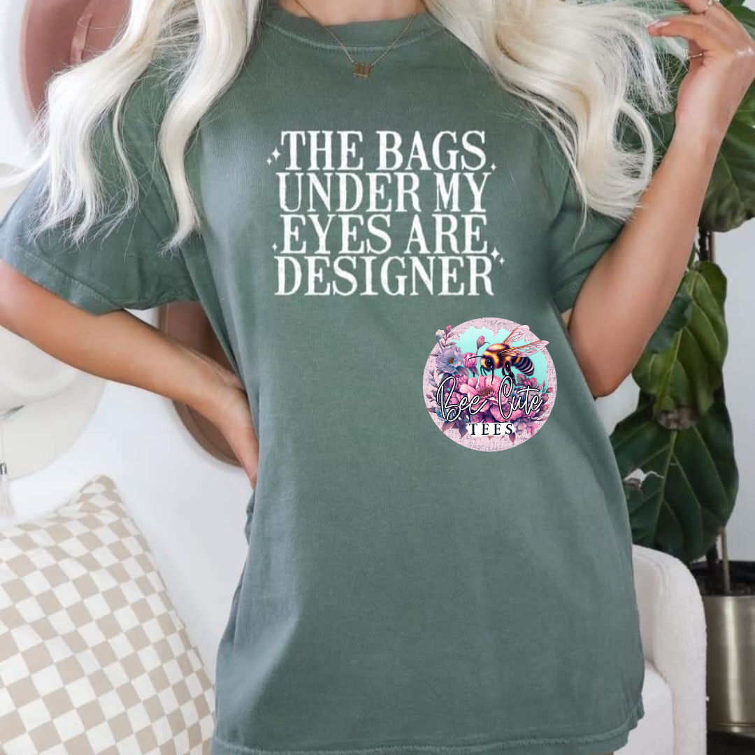 Person wearing a green t-shirt with a graphic and text, sitting on a couch.