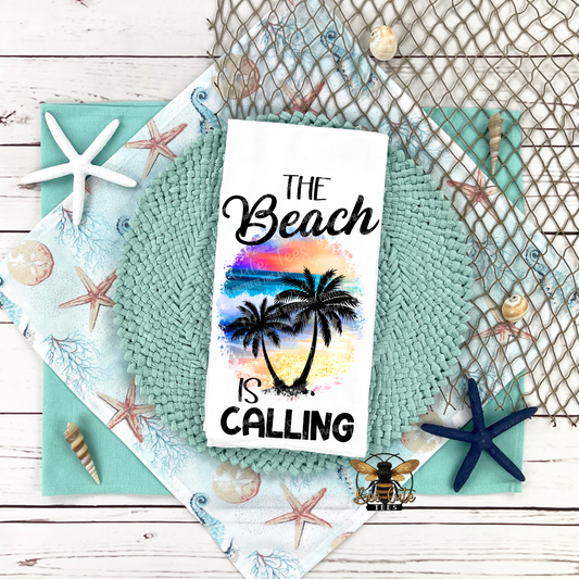 Tea towel with palm trees and 'The Beach is Calling' text on a decorative background with shells and starfish.