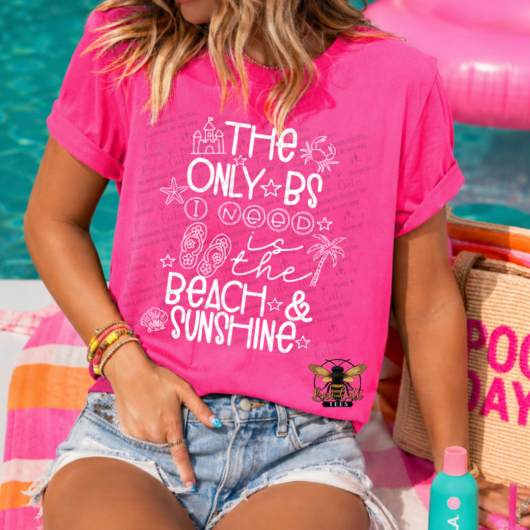 Person wearing a pink t-shirt with beach-themed text by a poolside.