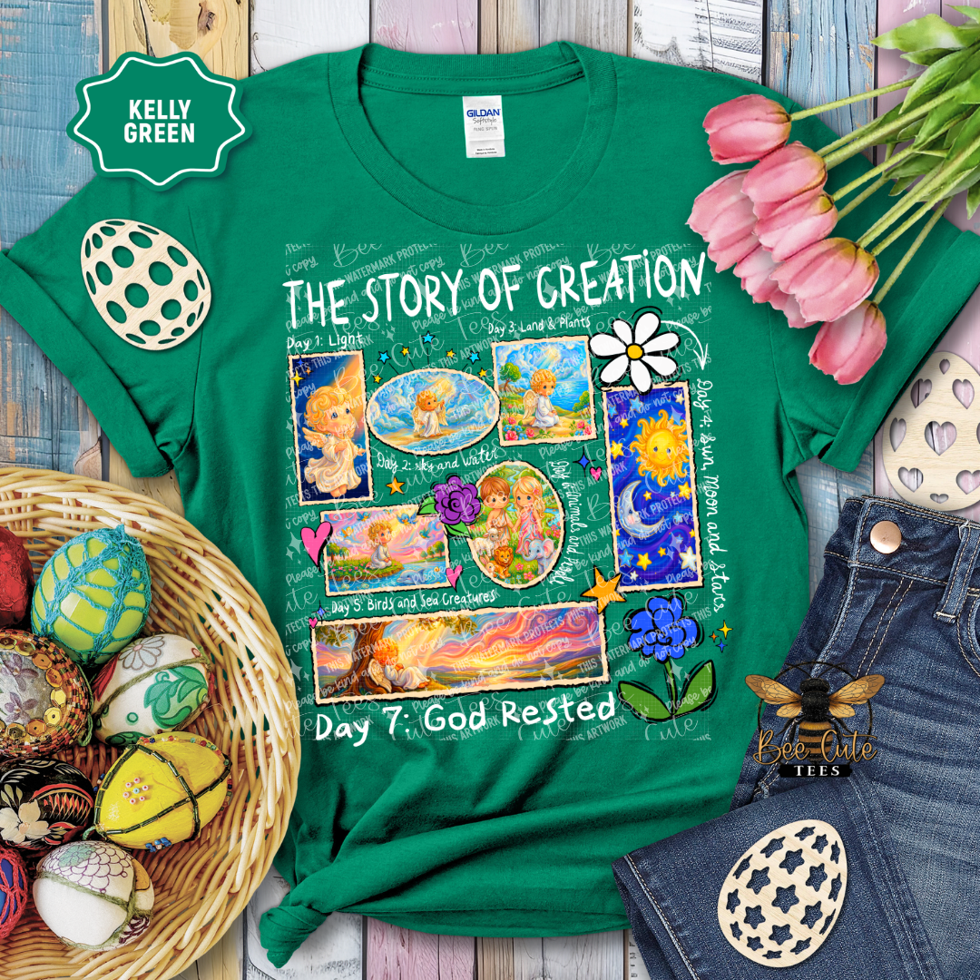Green t-shirt with 'The Story of Creation' design on a wooden surface with Easter decorations.