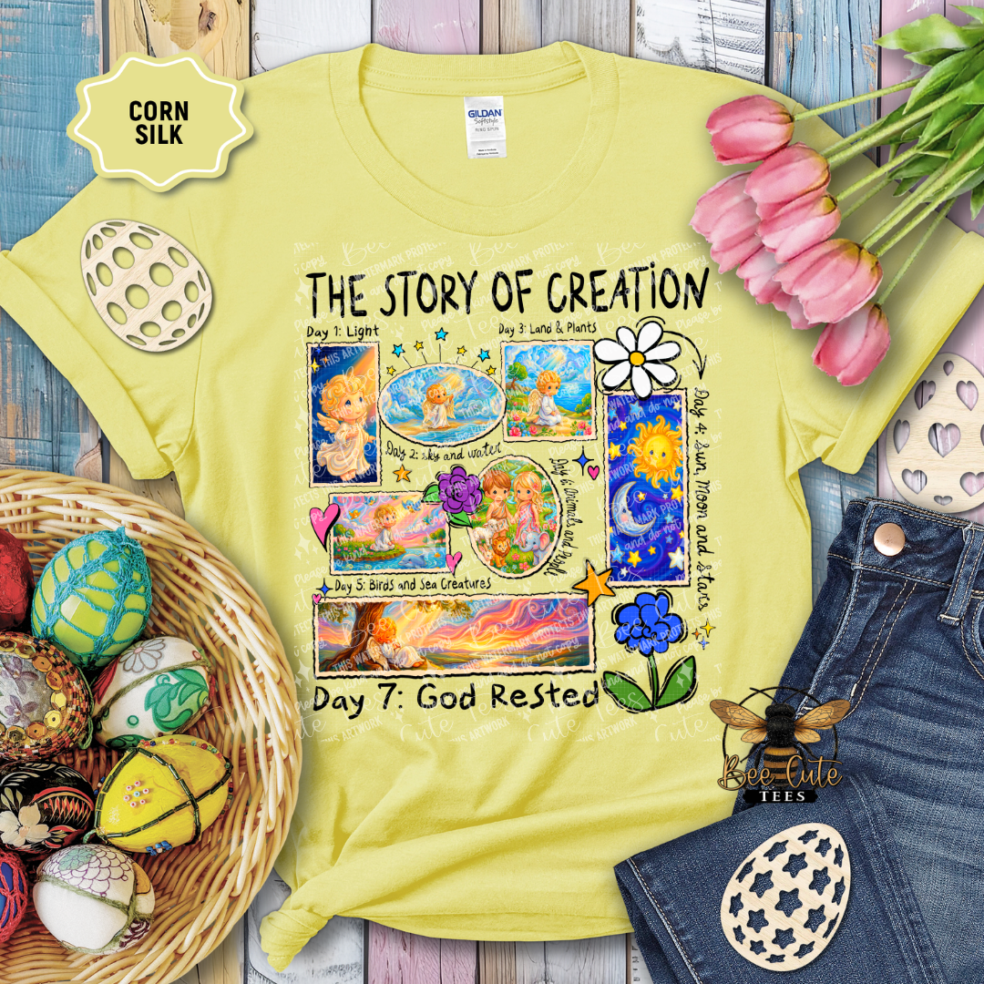 Yellow t-shirt with 'The Story of Creation' design, surrounded by Easter decorations on a wooden surface.
