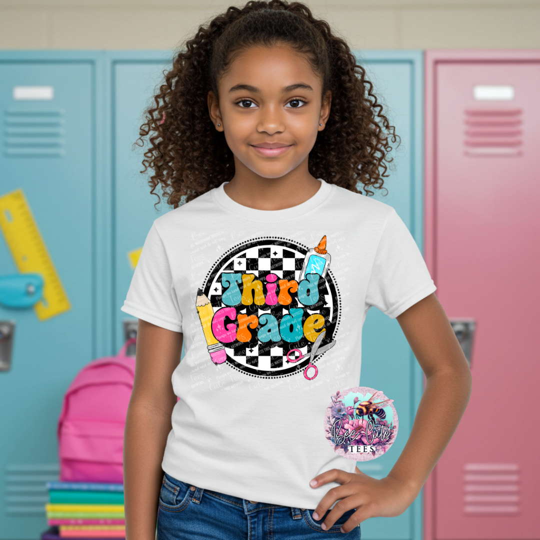 Young girl wearing a 'Third Grade' t-shirt in front of colorful lockers.