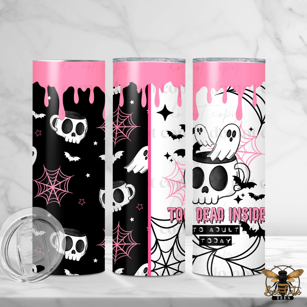 Three tall skinny tumblers with a pink, black, and white Halloween theme, displayed on a white marble surface with a clear lid in the foreground. The design features skulls, bats, spiderwebs, ghosts, and dripping pink accents.