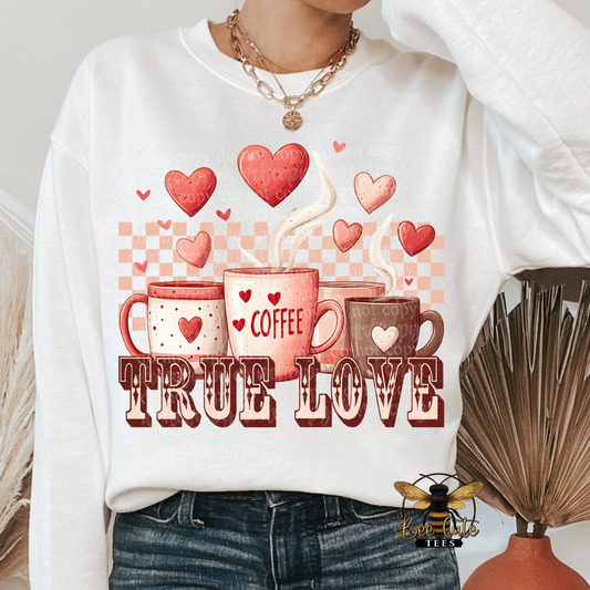 White sweatshirt with 'Coffee True Love' design featuring mugs and hearts.
