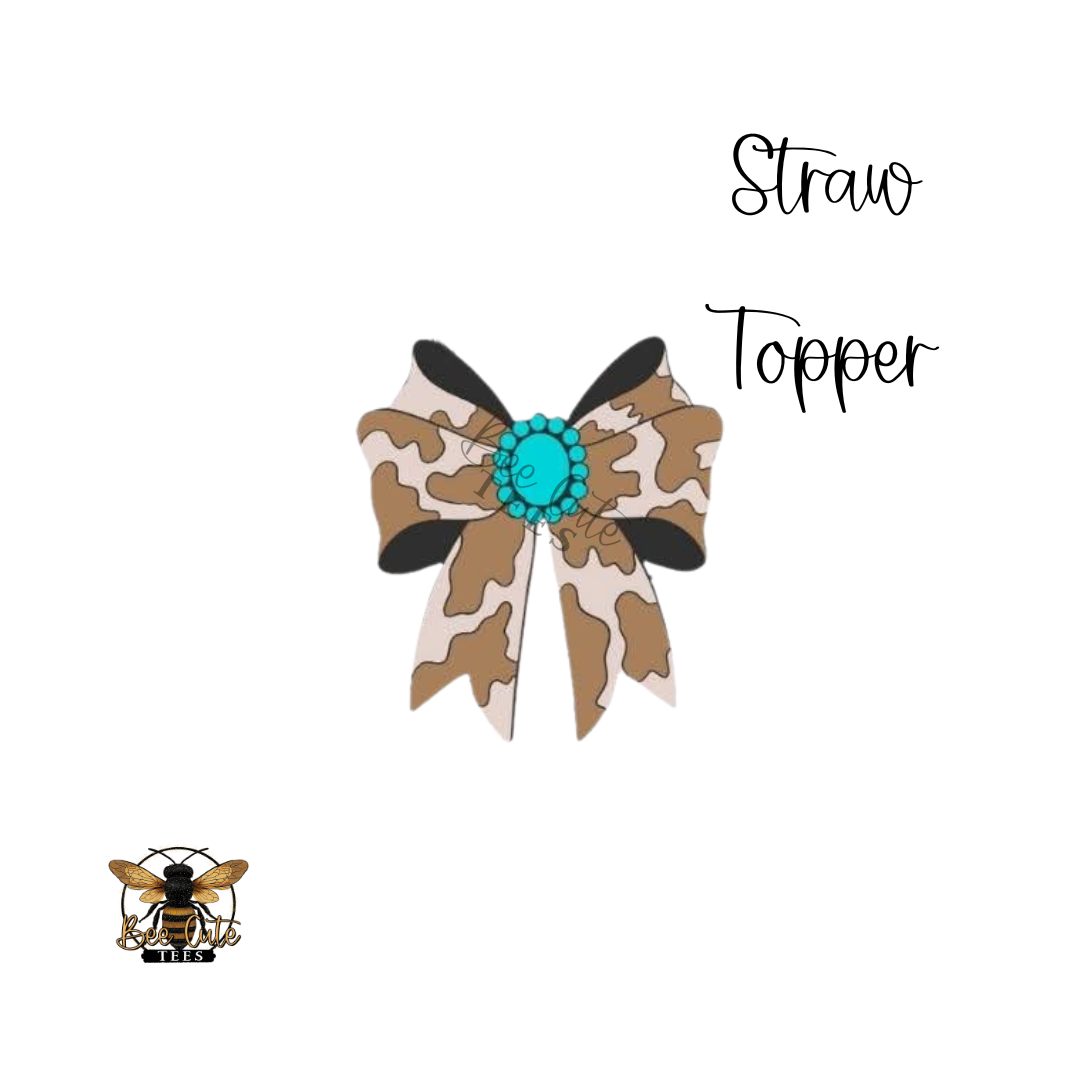Cow print bow with turquoise center labeled 'Straw Topper' on a white background