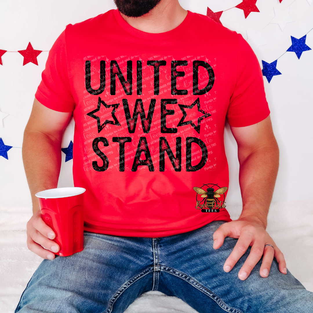 Person wearing a red 'UNITED WE STAND' t-shirt with a red cup, against a decorative background with stars.