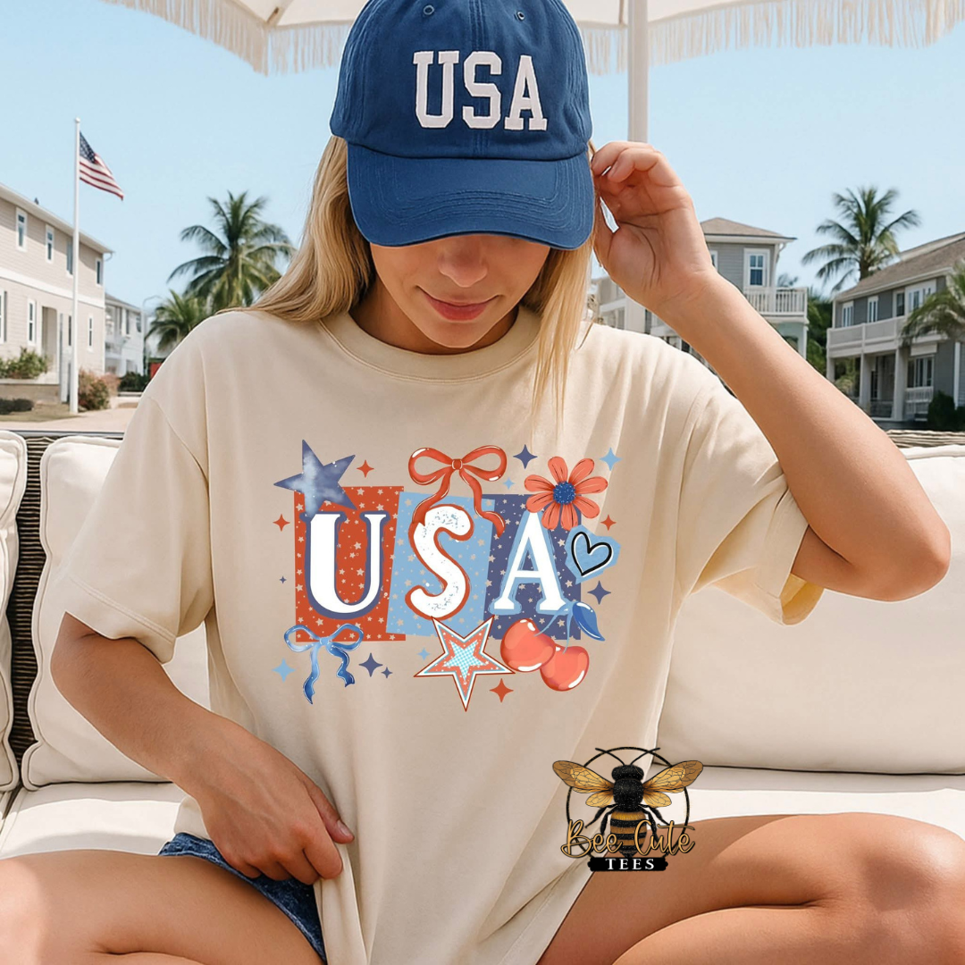 Person wearing a 'USA' t-shirt and cap outdoors