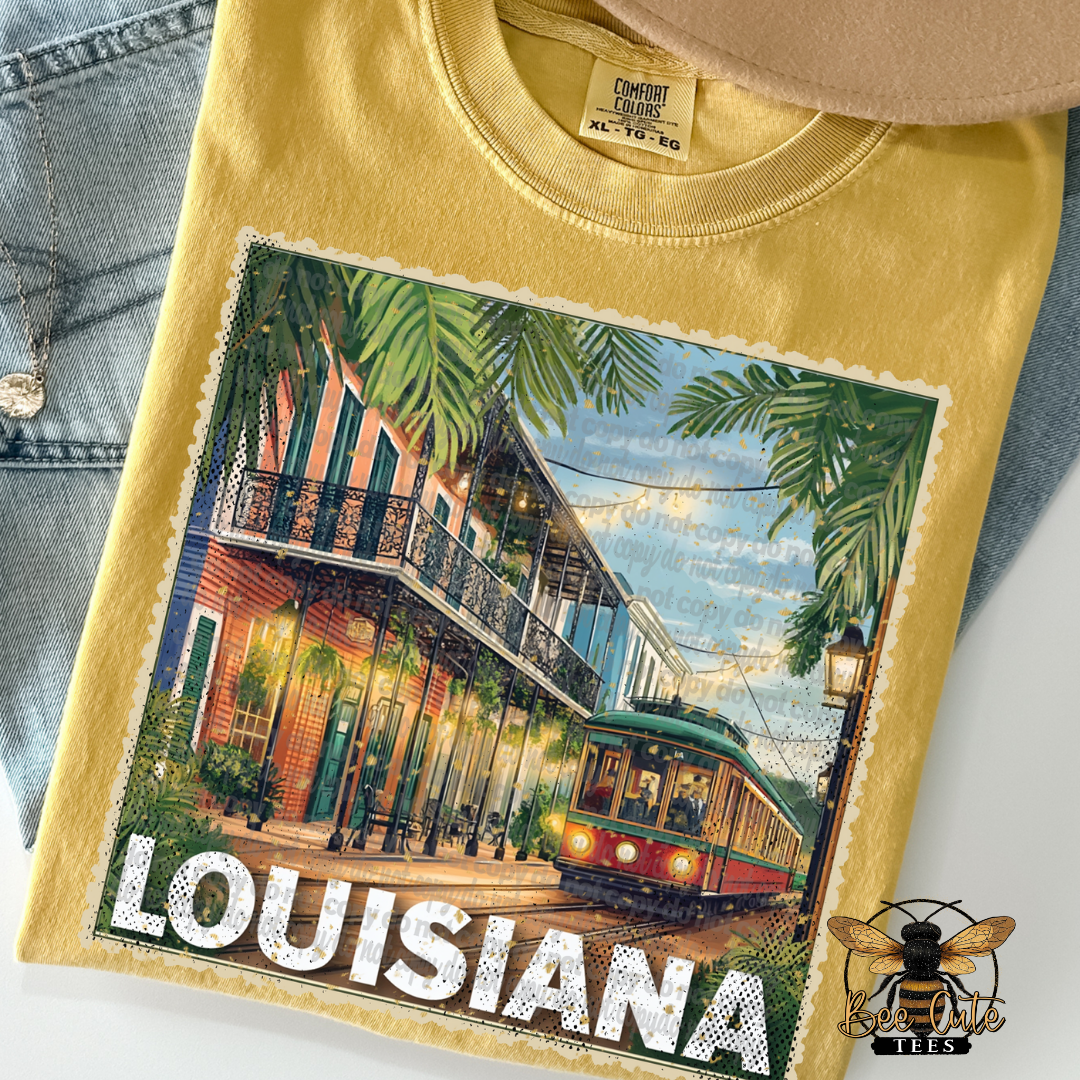 Yellow t-shirt with a graphic of a street scene in Louisiana and the word 'Louisiana' printed on it.