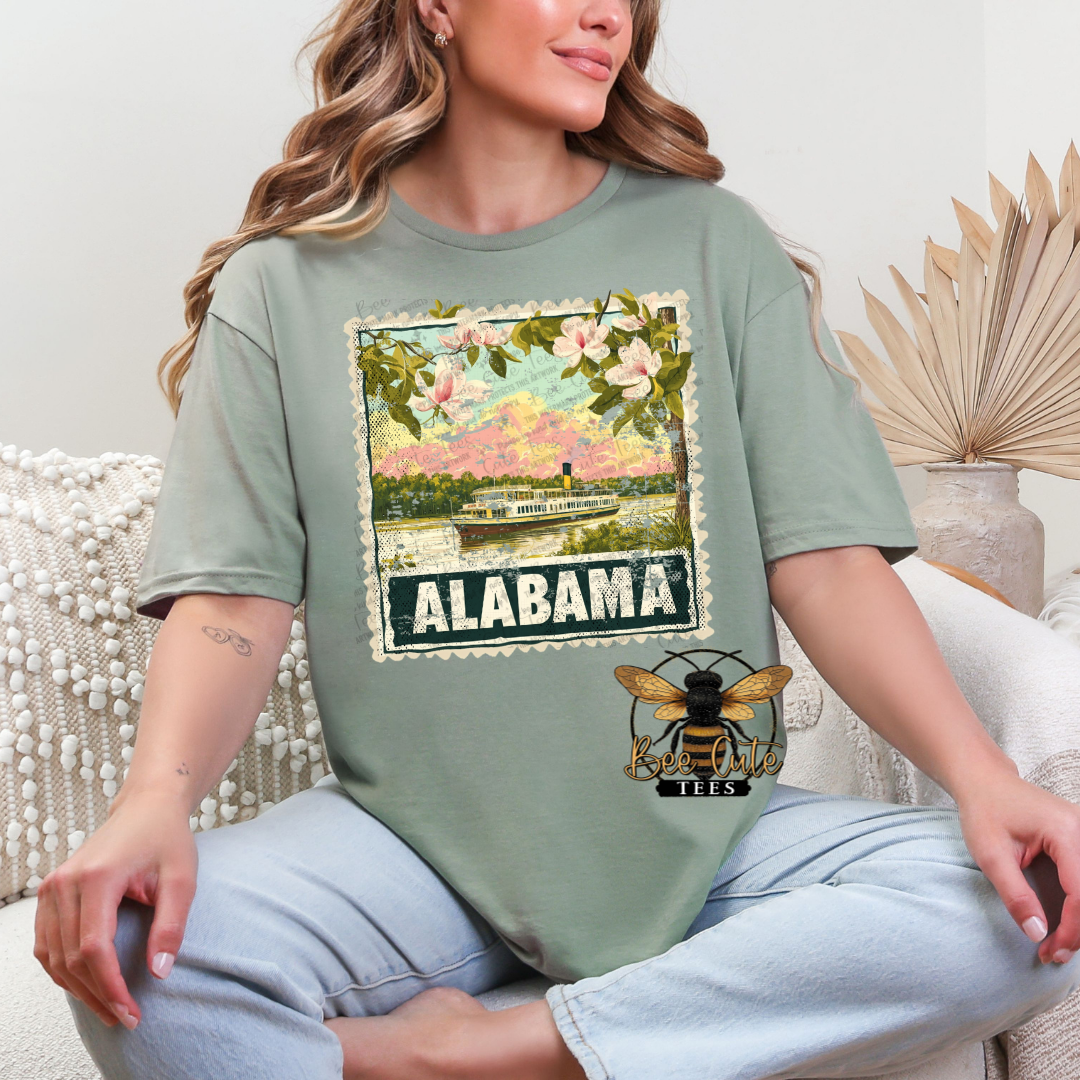 Person wearing a green t-shirt with an Alabama graphic design.