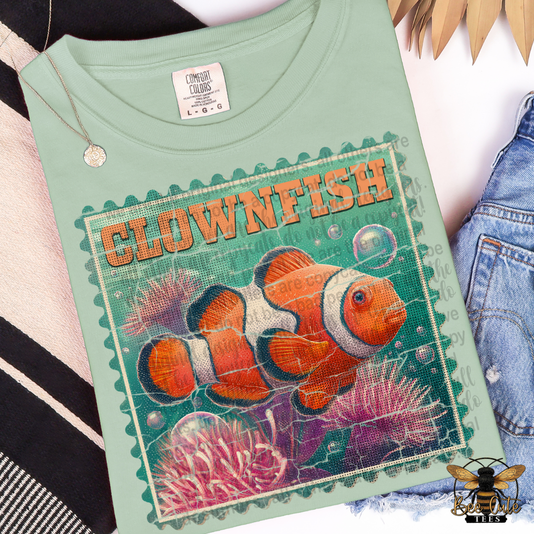 Light green t-shirt with clownfish design and 'Clownfish' text on a textured background.