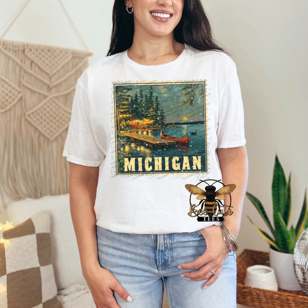 Person wearing a white t-shirt with a Michigan graphic design.