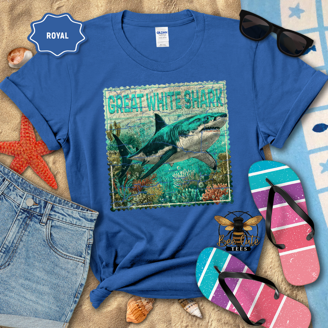 Blue t-shirt with a Great White Shark design on a beach-themed background