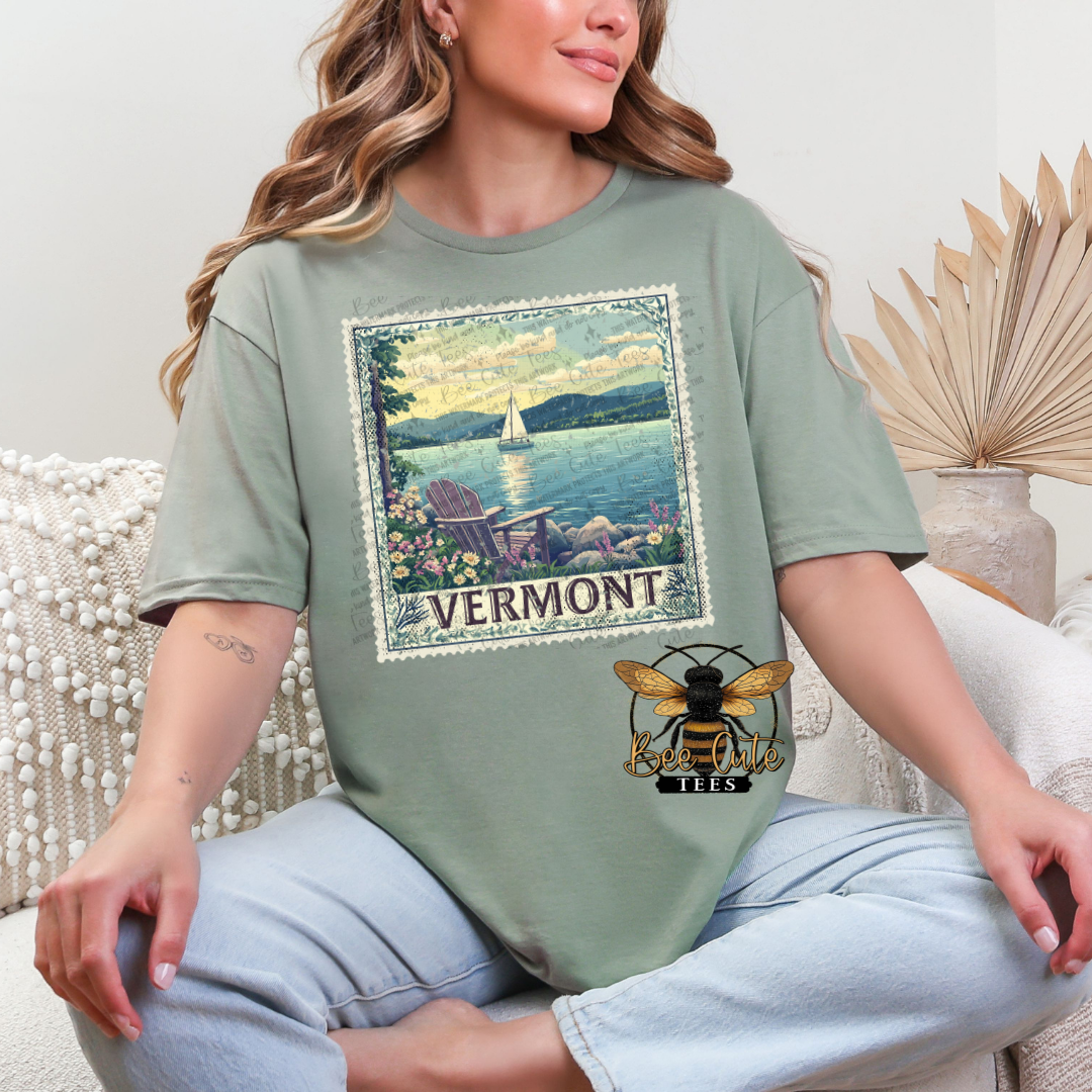 Person wearing a green t-shirt with Vermont-themed graphics