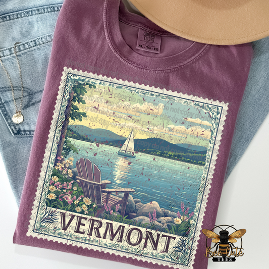 Purple t-shirt with Vermont graphic design on a white background