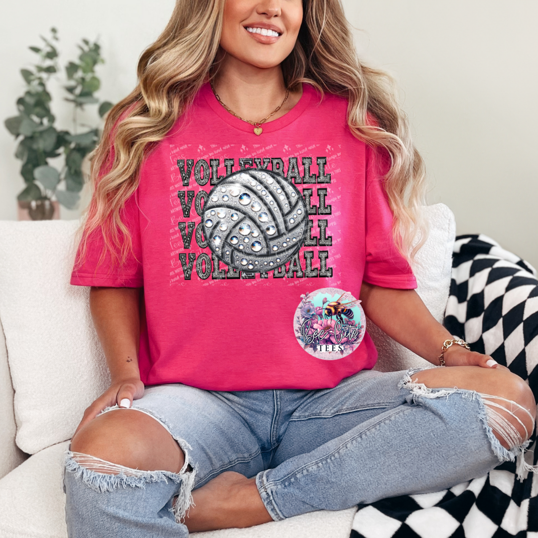 Person wearing a pink 'Volleyball' t-shirt sitting on a couch.