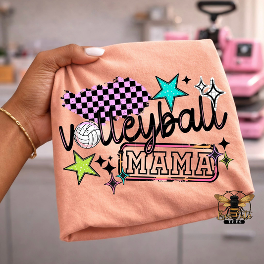 Orange t-shirt with 'Volleyball Mama' text and graphics held by a hand.