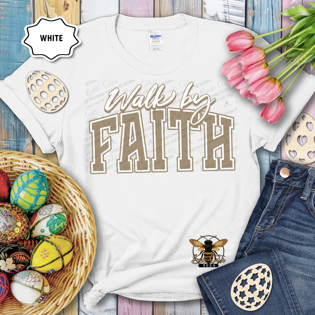 White t-shirt with 'Walk by Faith' text, surrounded by Easter decorations on a wooden surface.