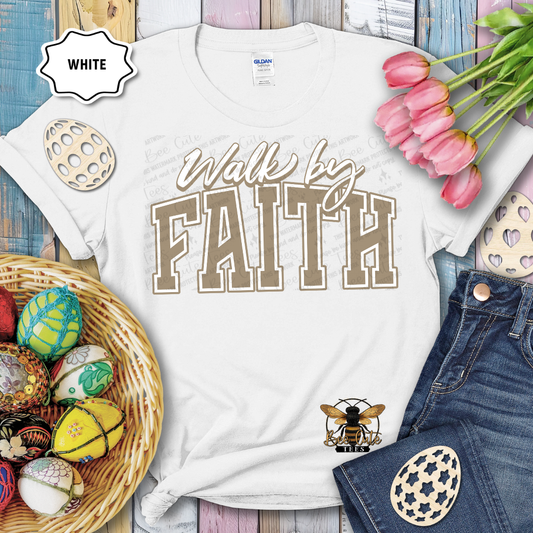 White t-shirt with 'Walk by Faith' text, surrounded by Easter decorations on a wooden surface.