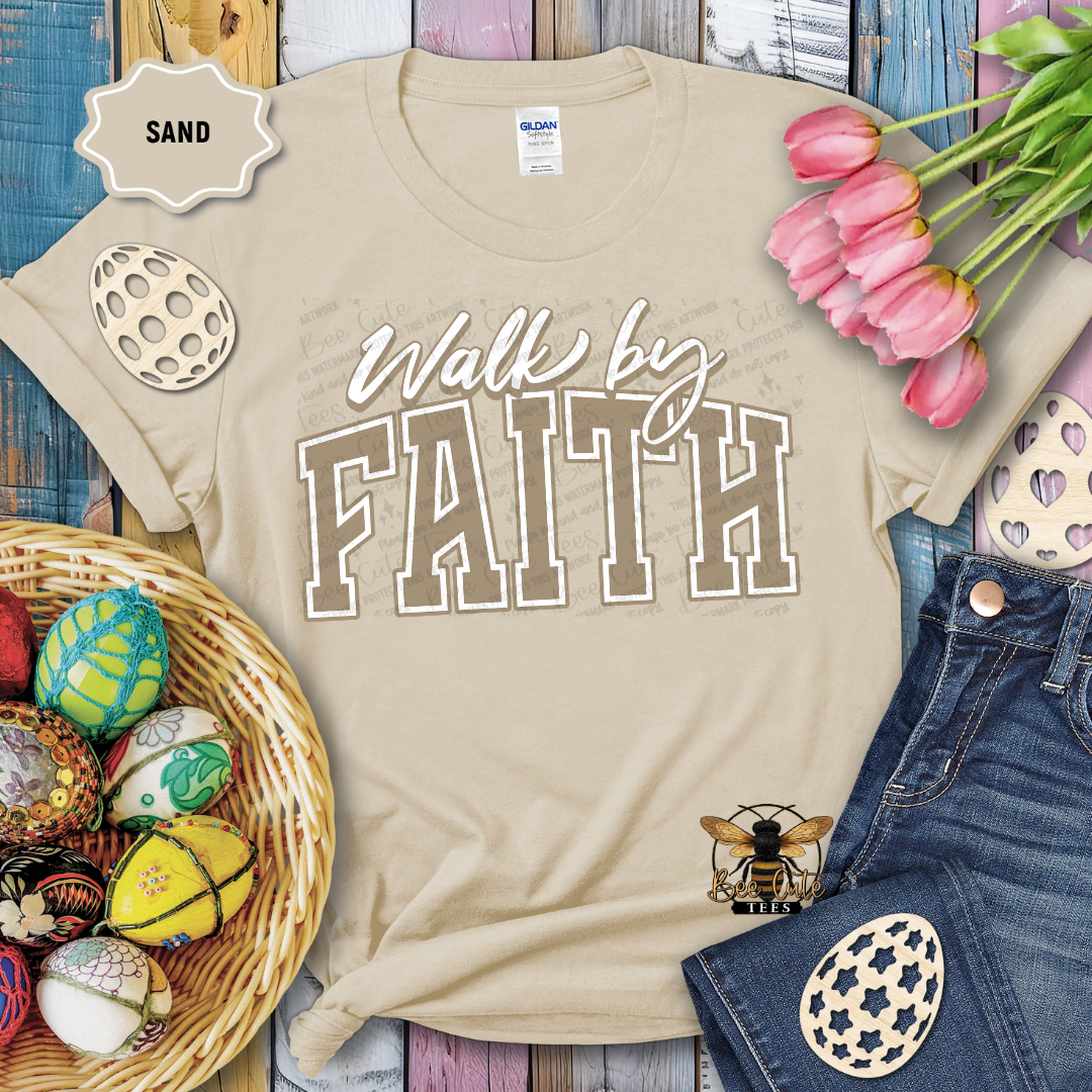 Beige t-shirt with 'Walk by Faith' text, surrounded by Easter decorations on a wooden surface.