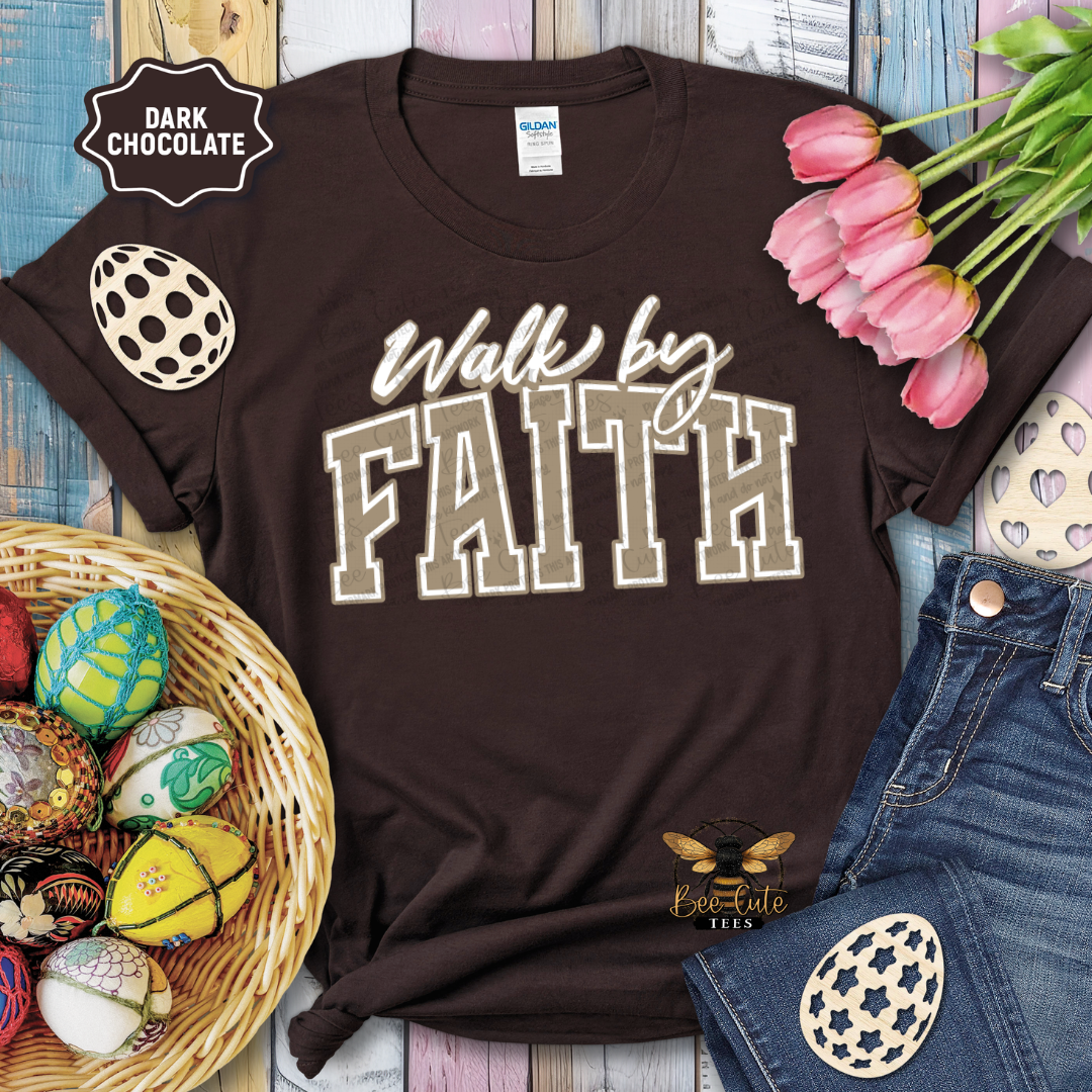 Brown t-shirt with 'Walk by Faith' text, surrounded by Easter decorations on a wooden surface.