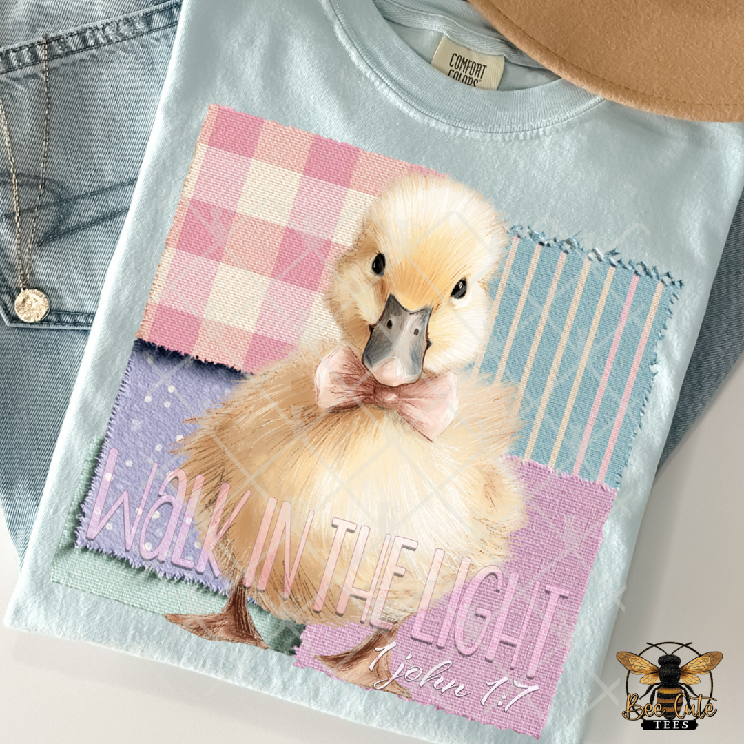 T-shirt with a duck graphic and 'Walk in the Light' text on a checkered background