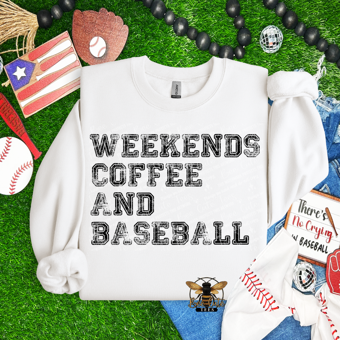White sweatshirt with 'Weekends Coffee and Baseball' text on a grass background with baseball-themed items.