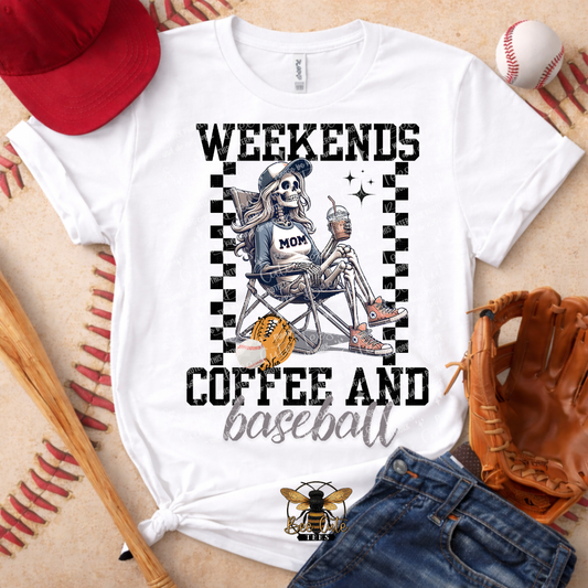 White t-shirt with skeleton graphic and text 'Weekends Coffee and Baseball' on a textured surface with baseball equipment.