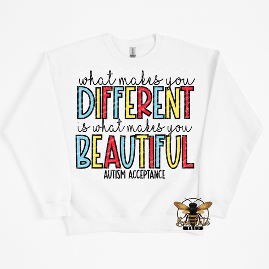 White sweatshirt with colorful text 'What makes you different is what makes you beautiful' and a bee logo on a white background.