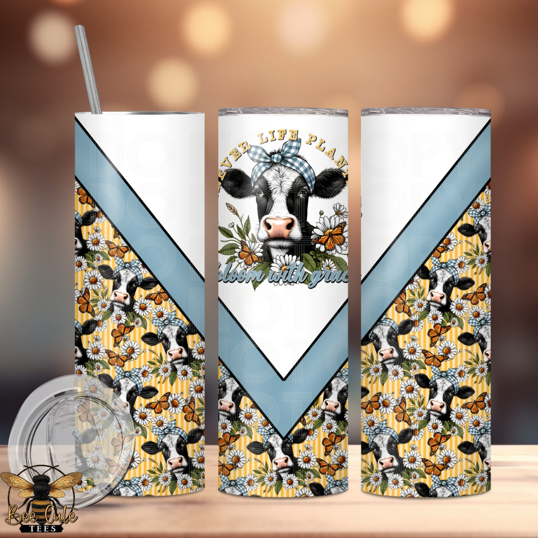 Three tumblers with cow and floral design on a wooden surface.